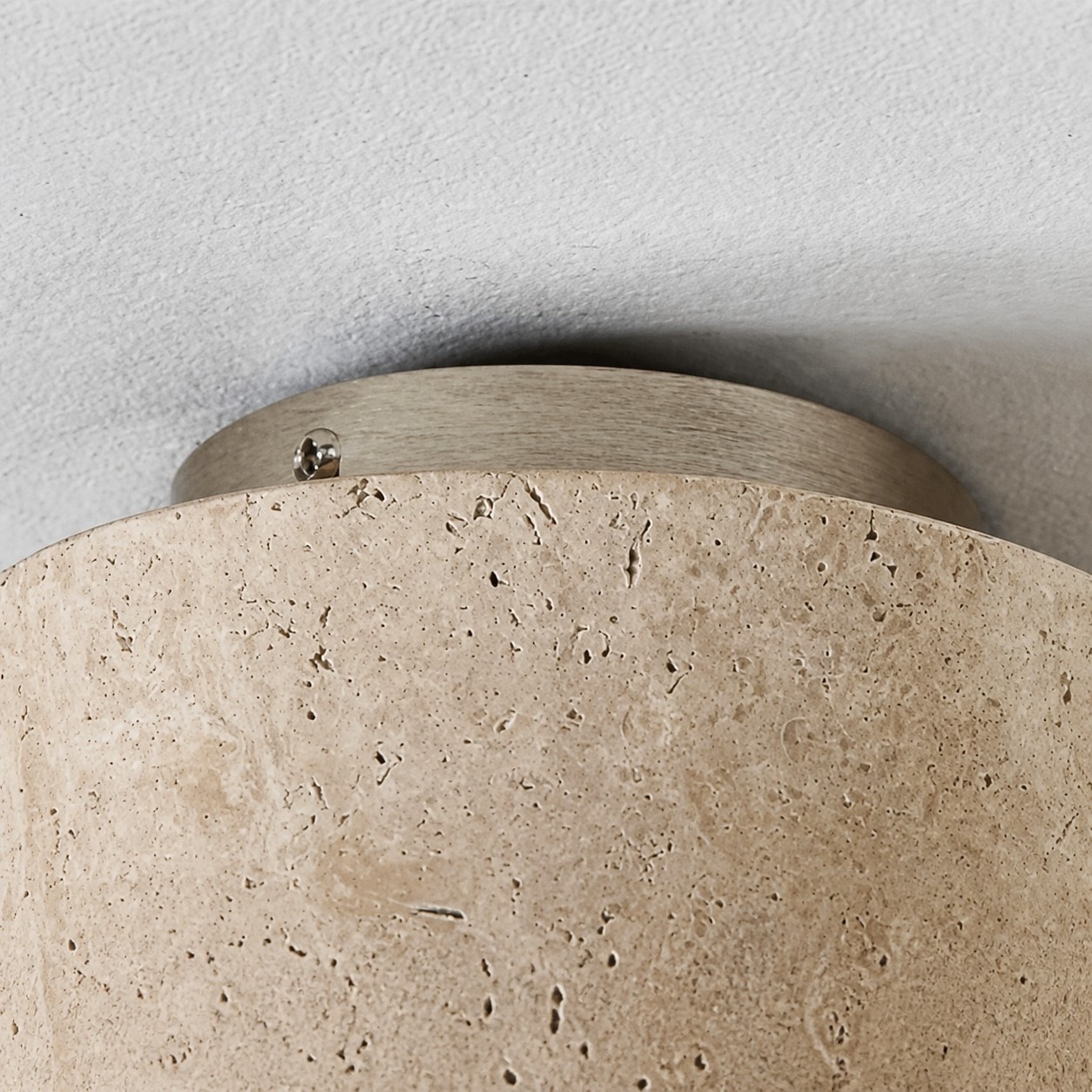 Metal ceiling base and natural travertine stone texture detail