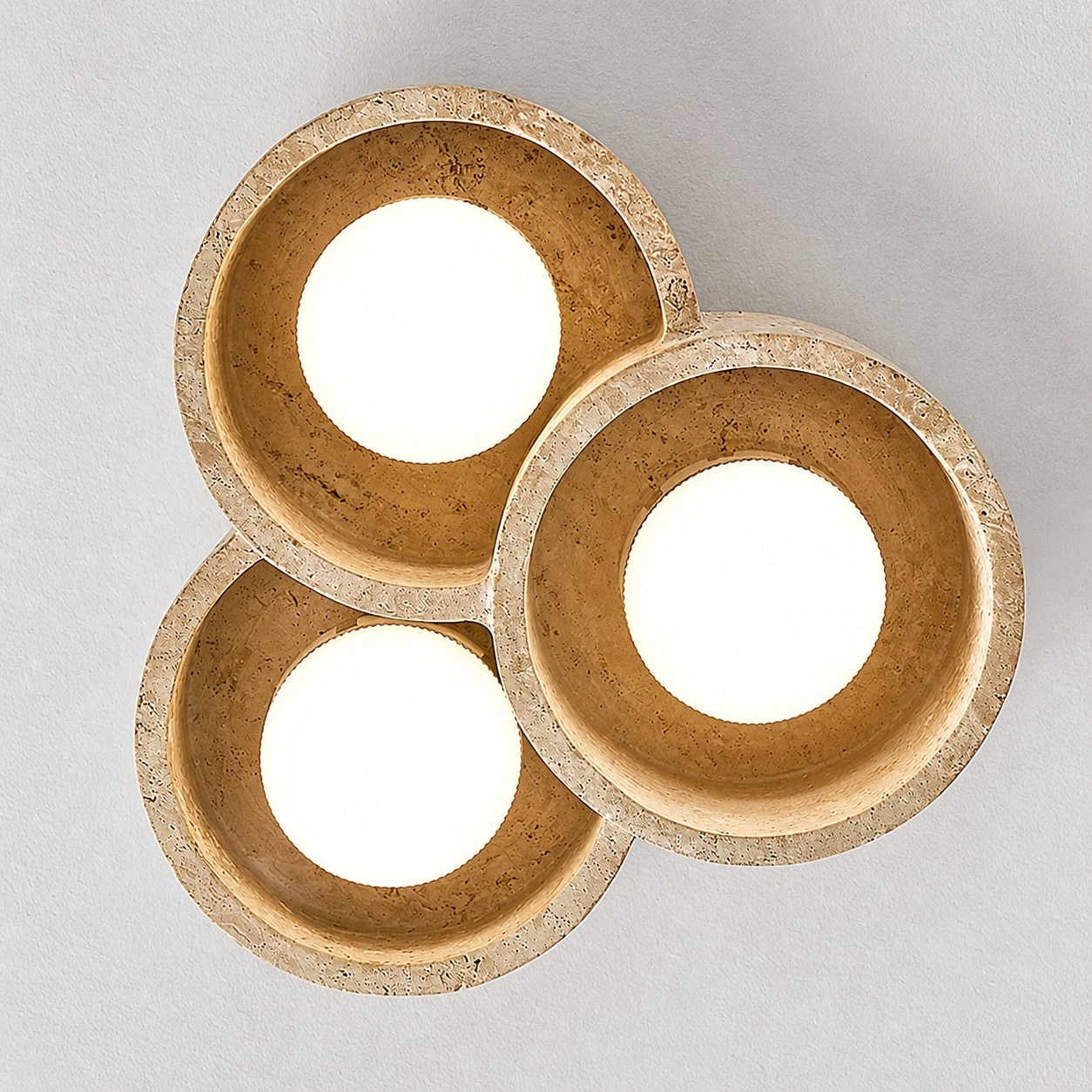 Bottom view of three round travertine light openings