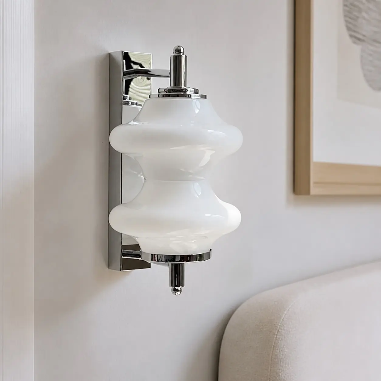 White glass wall light installed beside a bed