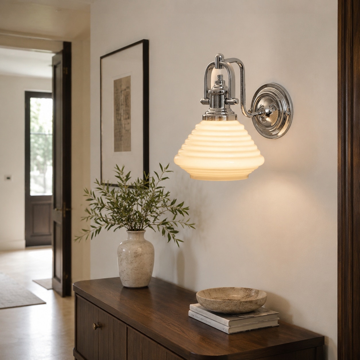 Creamy yellow glass wall sconce in entry console setting