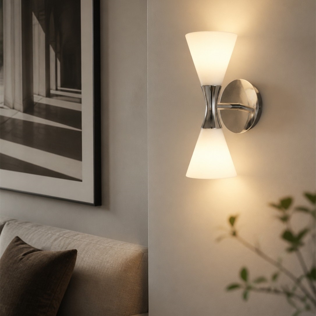 White and chrome Bauhaus wall sconce glowing on a hallway wall