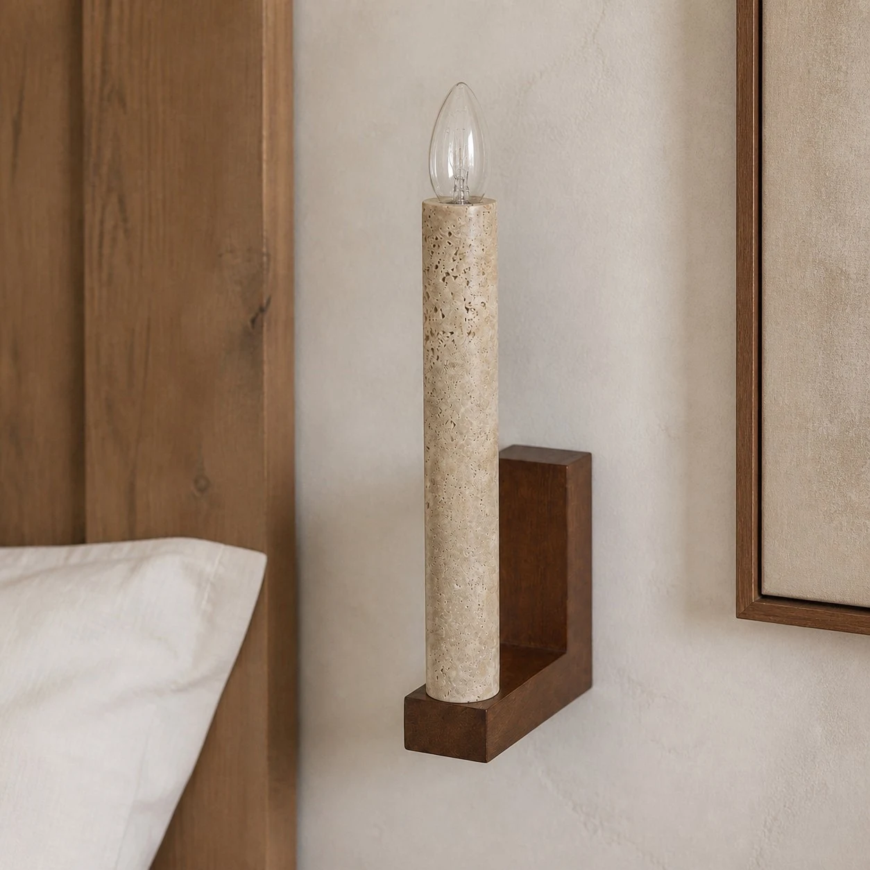 Natural travertine wall sconce beside a bed