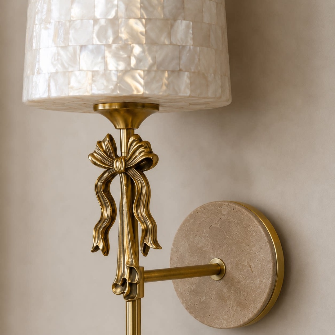 Detailed view of the shell shade, metal bow and travertine backplate