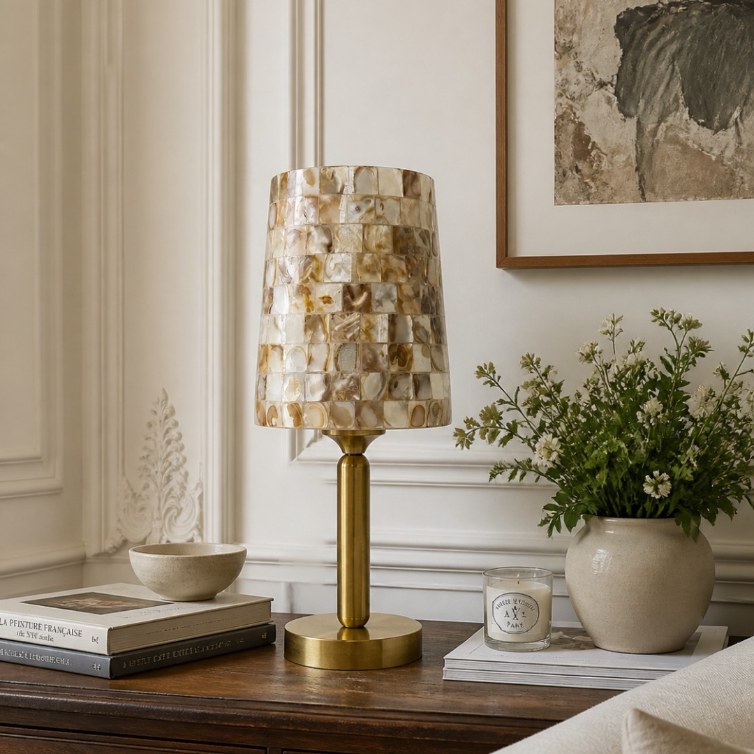 Beige Capiz shell table lamp styled on a wooden console