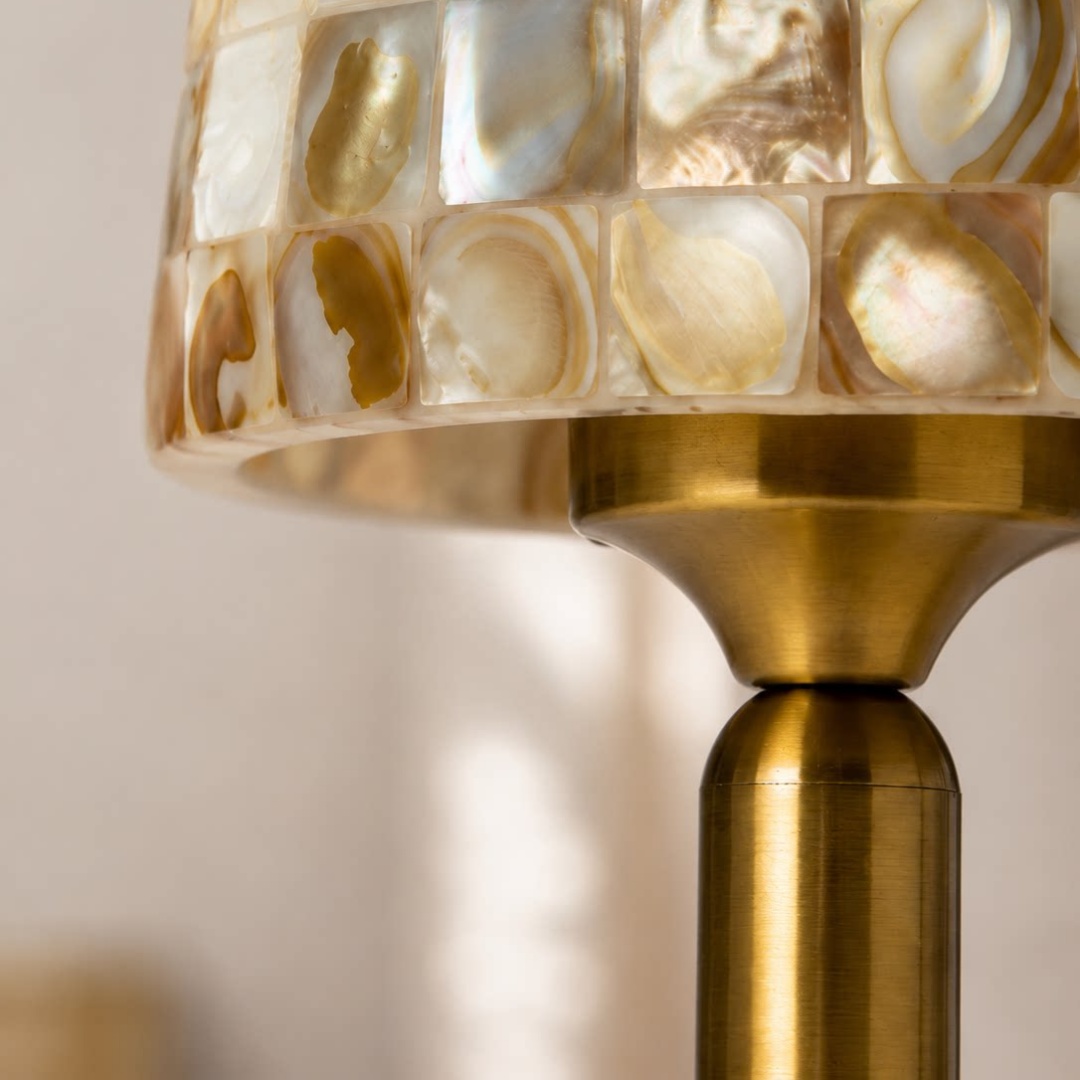 Close view of the shell shade edge and warm metal neck