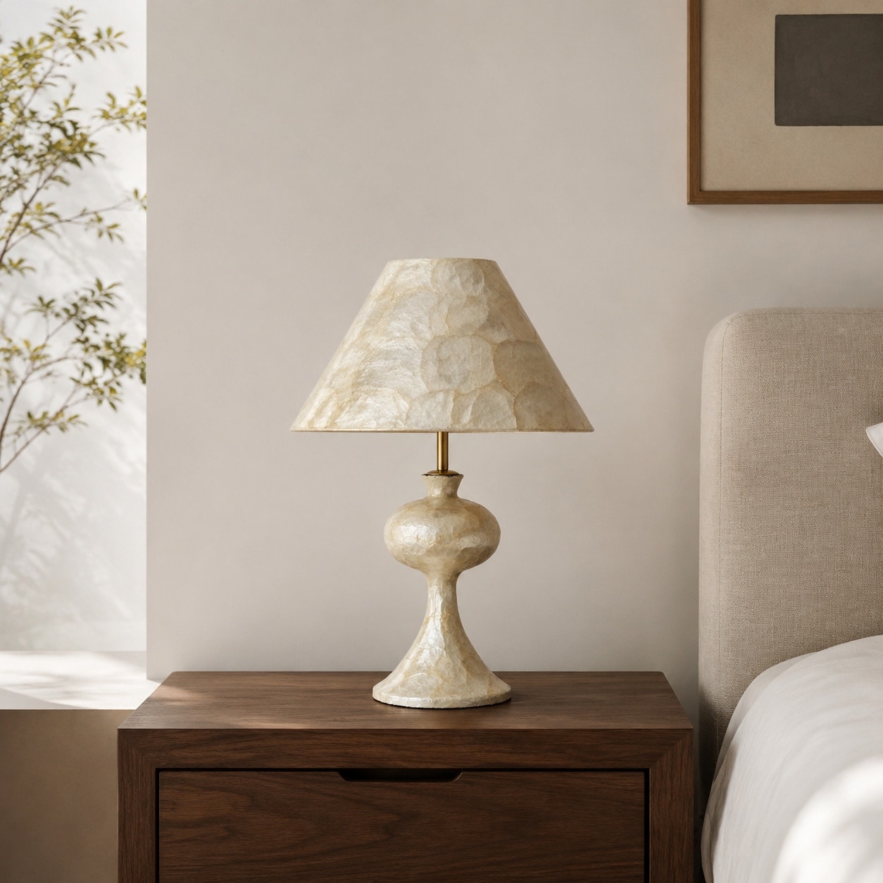 Capiz shell table lamp on a wooden bedside table in a warm bedroom