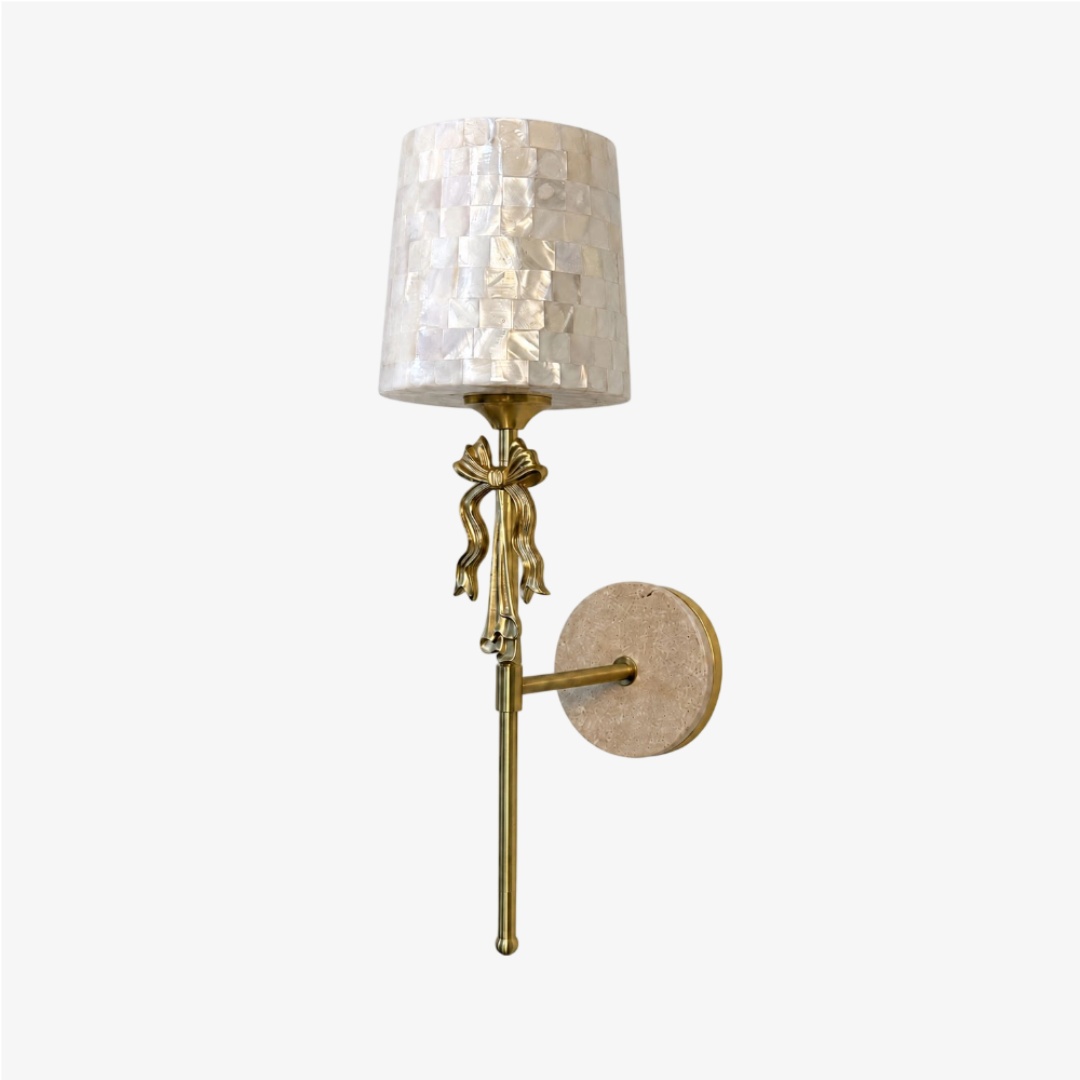 Beige Capiz shell bow wall sconce on a clean background