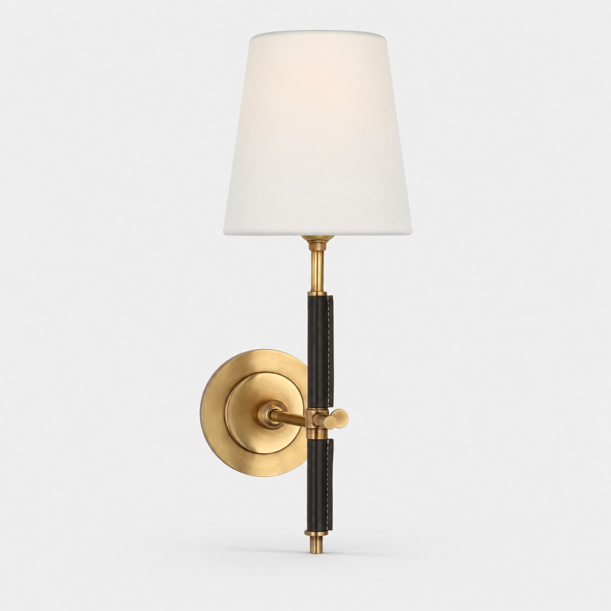 natural brass wall sconce with black leather and white fabric shade