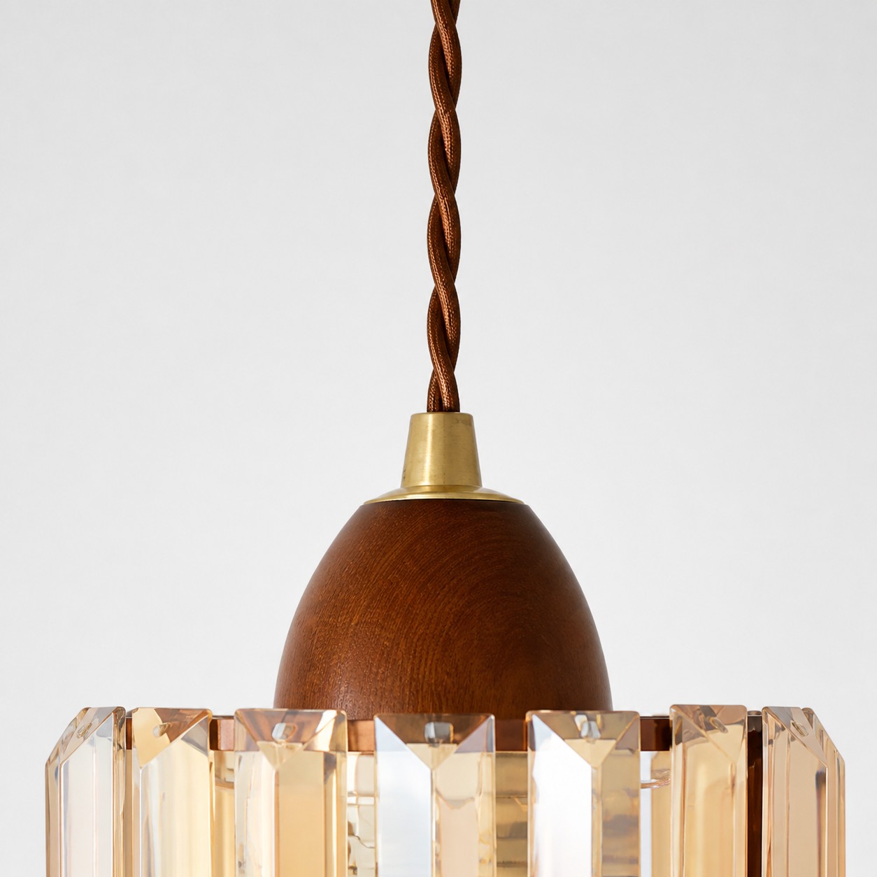 Suspension cord, wood-toned cap and crystal shade connection detail